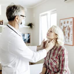 Shot of a male doctor examining a senior female patient in his medical office