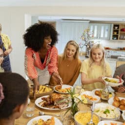 Happy family celebrating the holidays with a big, delicious dinner/